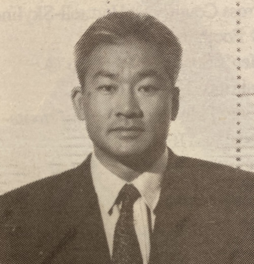 Paul Fong (La Voz, October 1993) Black and white vintage photo of a person in a suit and tie with short hair.