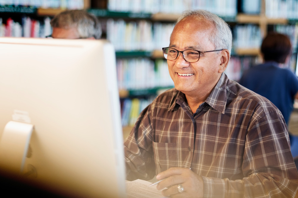 50+ man at computer smiling