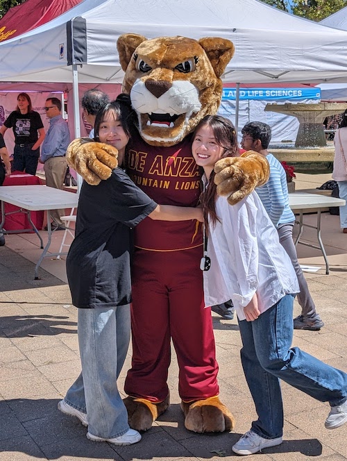 Roary hugging two students