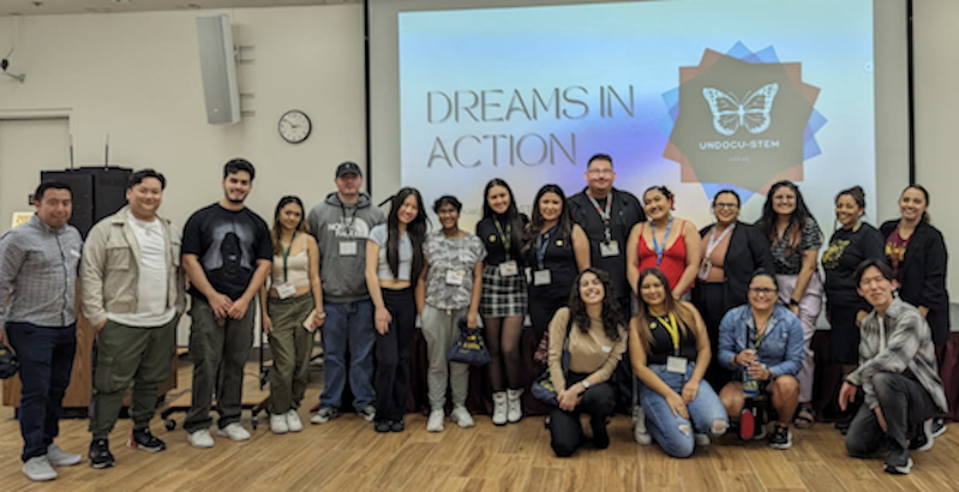 students in front of screen that says: Dreams in Action