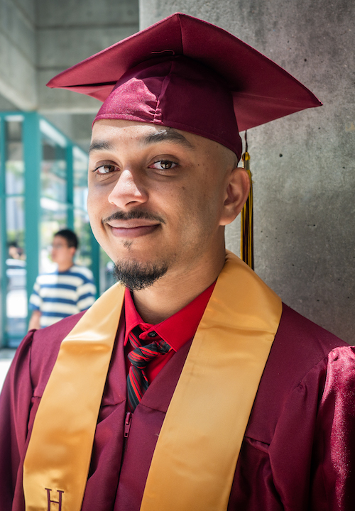 young man in grad cap and Honors sash