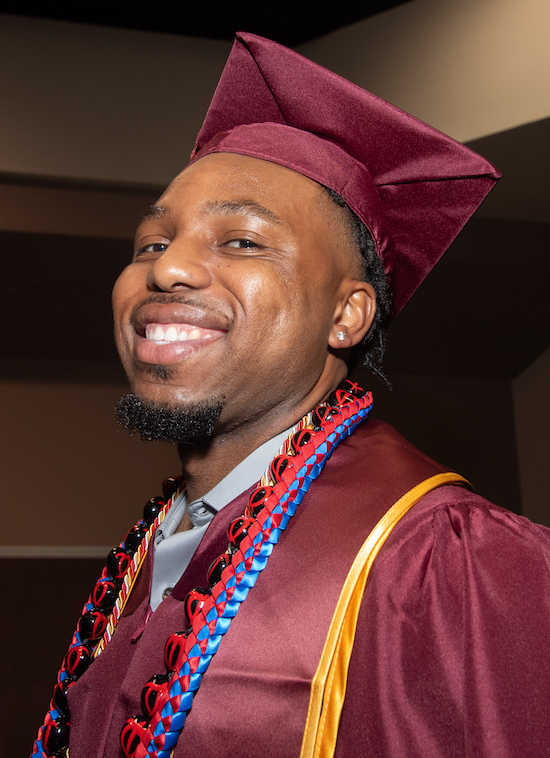 smiling young man in grad cap and gown