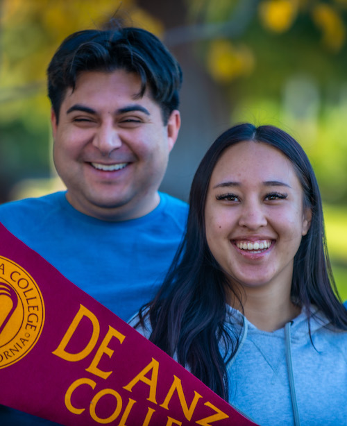 young woman in red sweater with De Anza notebook