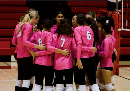 volleyball players in pink jerseys